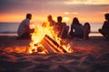 Bonfire on the beach with silhouettes of friends at sunset Royalty Free Stock Photo