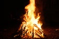 Bonfire burning at night, bright orange flames of fire