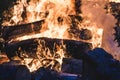 Bonfire burning trees at night. Large orange flame  on a black background. Fire on black. Brightly, heat, light, camping, Royalty Free Stock Photo