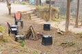 A bonfire at a camping site of a tourist resort. Empty plastic chairs arranged in a circle around the fire pit Royalty Free Stock Photo