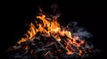 A bonfire with glowing coals. On a dark background