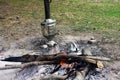 Bonfire, iron metal travel kettle, samovar and hot coals