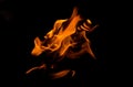 Bonfire with orange flames dark night in a under a blurred background, Flame, heat fire abstract background black background Royalty Free Stock Photo