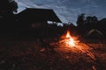 Bonfire with shadows of houses and tents With the morning light Royalty Free Stock Photo