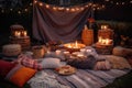 bonfire surrounded by cozy blankets and plates of food for bonfire party