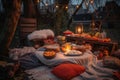 bonfire surrounded by cozy blankets and plates of food for bonfire party