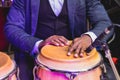 Bongo drummer percussionist performing on a stage with conga drums set kit during jazz rock show performance, tumbadora quinto