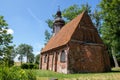 Bonin, zachodniopomorskie / Polska - June 28, 2019: A small red brick church. Temple with a wooden tower in Central Europe