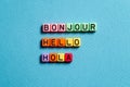 Bonjour hello hola - word concept on cubes Royalty Free Stock Photo