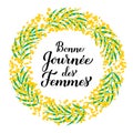 Bonne Journee des Femmes - Happy Womens Day in French. Calligraphy hand lettering with floral mimosa wreath