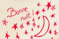 Bonne nuit good night handwriting text close up isolated on yellow paper with copy space