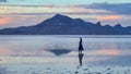 Bonneville - Woman walking into the sunset of lake Bonneville Salt Flats, Wendover, Western Utah, USA, America Royalty Free Stock Photo