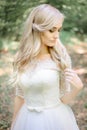 Bonny blonde bride touches her hair delicately Royalty Free Stock Photo