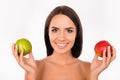 Bonny girl chosing between green and red apples Royalty Free Stock Photo