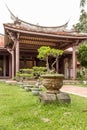 Bonsai trees in row outside temple