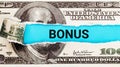 BONUS word written on with American Dollar-bills. The word BONUS on dollar usa background. Finance and money concept. Royalty Free Stock Photo