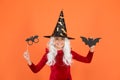 Boo to you. Little wicked witch orange background. Small child wear witch costume for holiday celebration. Halloween