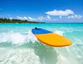 A boogie board half-submerged in a shallow ocean wave, ready for a ride, hinting at beach fun Royalty Free Stock Photo