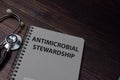 Book about AMS Antimicrobial Stewardship isolated on wooden table Royalty Free Stock Photo
