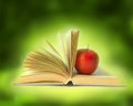 Book with apple in bright background Royalty Free Stock Photo