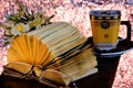 Book on the background of a Cup of coffee flowers. The book is a source of important knowledge, literary or scientific work,