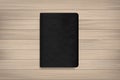 Book with black cover on wood for background. Vector