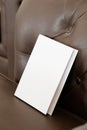 Book with blank cover on leather sofa Royalty Free Stock Photo