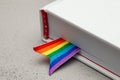 Book with bookmark and rainbow ribbon of LGBT pride