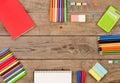 book, calculator, notepad, crayons and other stationery on brown wooden table Royalty Free Stock Photo