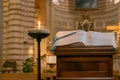 The book of Catholic Church liturgy near the burning lamp in the