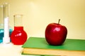 Book and chemical test tubes on a yellow background. Klas studying chemistry. Shocking education. Royalty Free Stock Photo