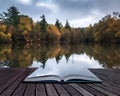 Book concept Beautiful vibrant Autumn woodland reflecions in cal