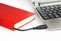 Book connected to a computer via USB cable Royalty Free Stock Photo