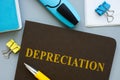 Book about Depreciation and pen on the table.