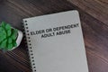 The book of Elder or Dependent Adult Abuse isolated on Wooden Table