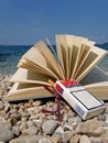 Book, eyeglasses, cigarette on beach Royalty Free Stock Photo
