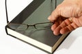 Book and eyeglasses in hand Royalty Free Stock Photo