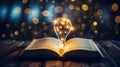 book of fiction on top bokeh light bulb