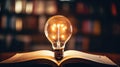 book of fiction on top bokeh light bulb Royalty Free Stock Photo