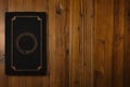 Book with a gilded Ouroboros on a wooden desk