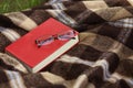 Book and glasses on the plaid, reading Royalty Free Stock Photo