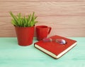Book glasses pot with grass red cup of coffee vintage on table wooden concept Royalty Free Stock Photo