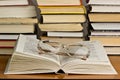 Book and glasses on table in library Royalty Free Stock Photo