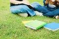 A book on the grass and student university reading a book back