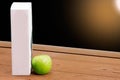 Book and Green apple on chalkboard background. Royalty Free Stock Photo