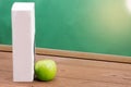 Book and Green apple on chalkboard background. Royalty Free Stock Photo