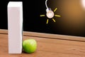 Book and Green apple on chalkboard background. Royalty Free Stock Photo