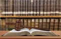 Book with judge hammer on bookshelves background Royalty Free Stock Photo