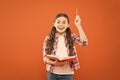 That book has given me several ideas. Little girl writing down her idea into diary. Small child pointing pen up having Royalty Free Stock Photo