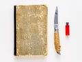 Book, knife and ampoule with blood on a white background. Set for magic